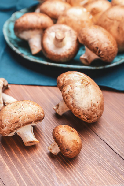 Raw mushrooms on wooden table - Fotó, kép