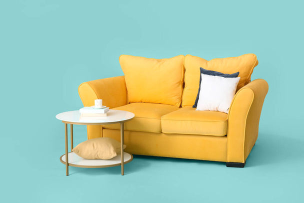 Stylish sofa and table on color background - Photo, Image