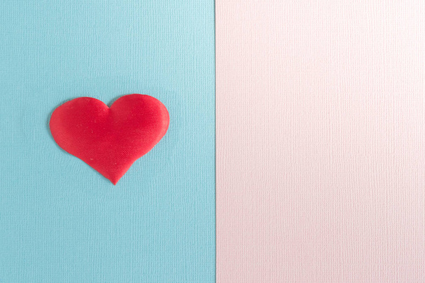 The textured pink-blue background is divided into equal parts. The blue part has a red heart. Copy space - Fotografie, Obrázek