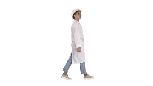 Engineer woman walking and checking the object on white background. - Foto, imagen