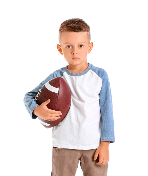 白い背景にラグビーボールを持つ小さな男の子 - 写真・画像