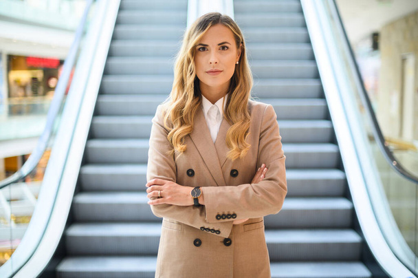 Smiling businesswoman portrait in front of mobile stairs - Fotoğraf, Görsel