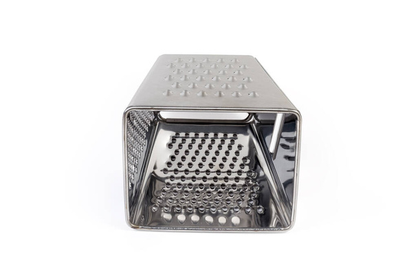 Stainless steel kitchen box four-sided grater with various grating and slicing surfaces on a white background, bottom view - Photo, Image