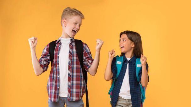 Excited boy and girl screaming with joy shaking fists - Photo, Image