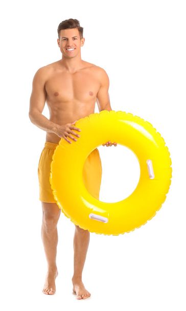Young man with inflatable ring on white background - Foto, imagen