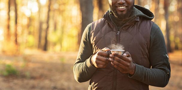 Cropped of man staying in forest with cup of tea - Photo, Image