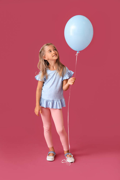 Little girl with balloon on color background - Photo, image