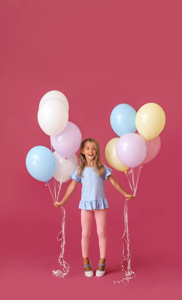 Little girl with balloons on color background - Foto, imagen