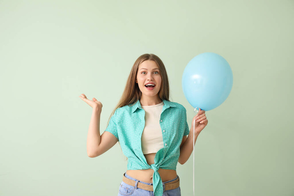 Young woman with balloon on color background - Fotografie, Obrázek