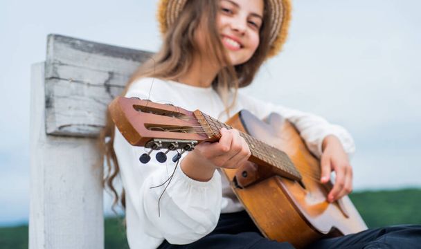 have fun on party. guitar player or guitarist. singer with guitar. girl playing guitar. musical school concept. country music. music is my life. child with acoustic string instrument. selective focus - Zdjęcie, obraz