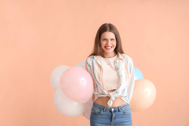 Young woman with balloons on color background - Photo, Image