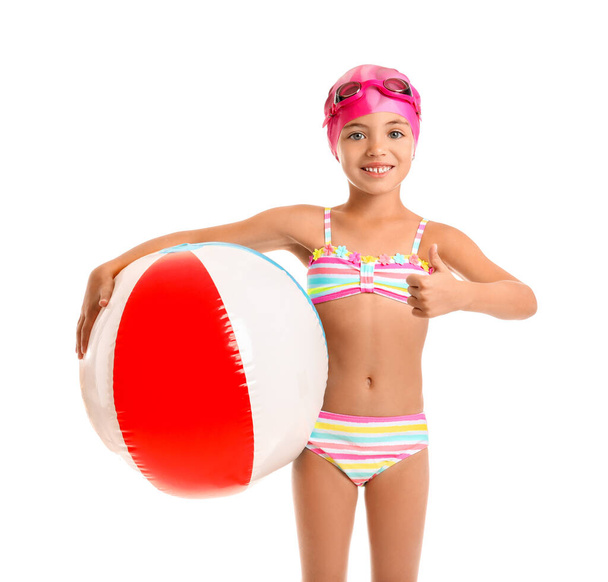 Little girl in swimsuit and with ball on white background - Фото, зображення