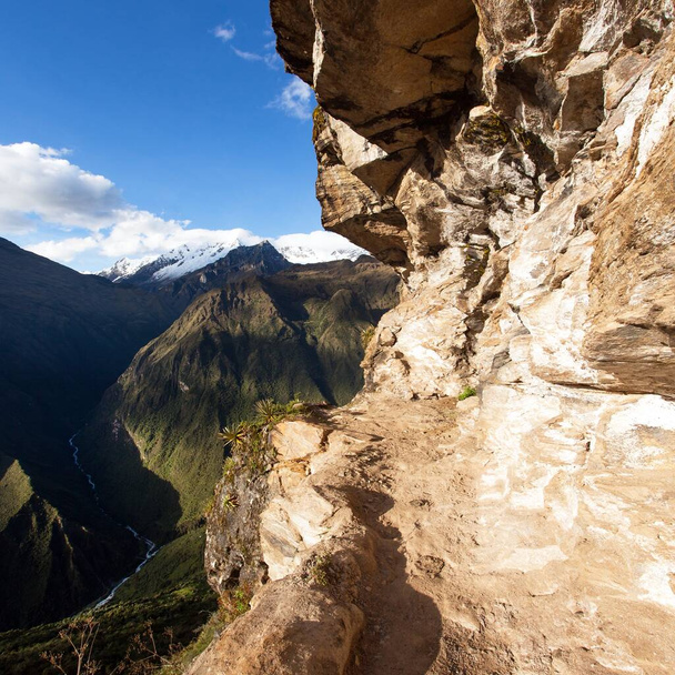pathway and rock face, Mount Saksarayuq, Andes mountains, Choquequirao trekking trail near Machu Picchu, Inca trail, Cuzco or Cusco region in Peru  - Фото, изображение