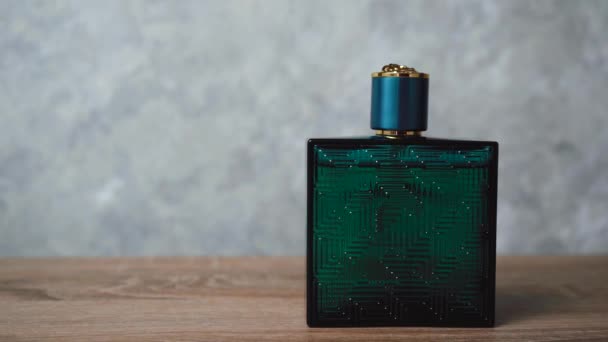 blue Cologne with perfume stands on a wooden background - Footage, Video