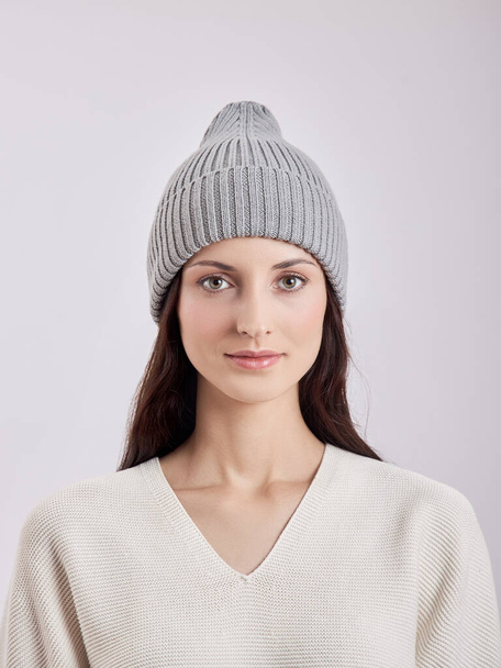 Beautiful woman in autumn hat on a white background. Autumn warm clothes - Фото, зображення