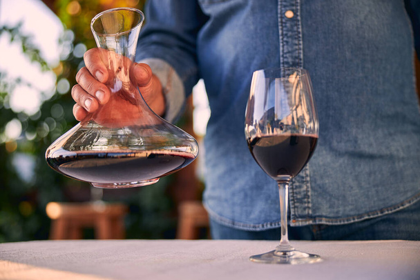 Old red wine in the glass and in decanter - Foto, afbeelding
