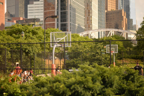 Public basketball court with modern skyscrapers on background - Foto, imagen