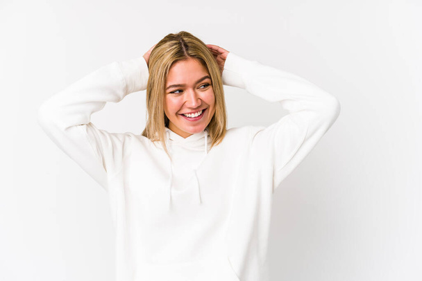 Young blonde caucasian woman isolated laughs joyfully keeping hands on head. Happiness concept. - Photo, Image