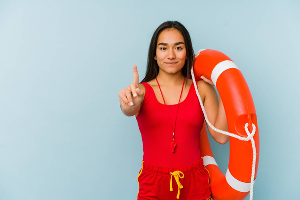 Young asian lifeguard woman isolated showing number one with finger. - Photo, Image