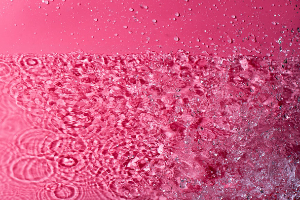 splash of water on a red background. Abstract wallpaper - Foto, Imagen