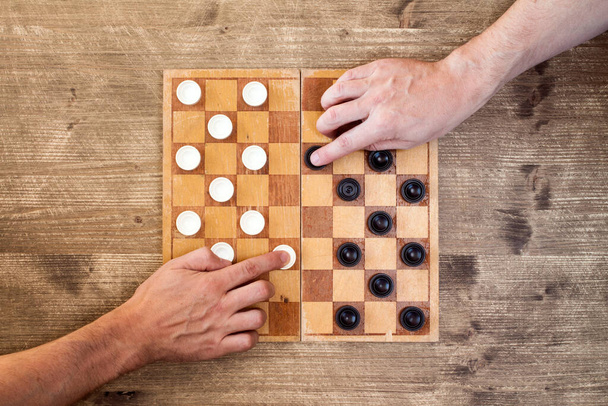 Two players starting play draughts checkers board game - Foto, Imagem