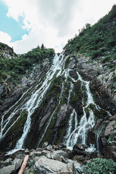 A vertical shot of a waterfall cascading down - Fotó, kép