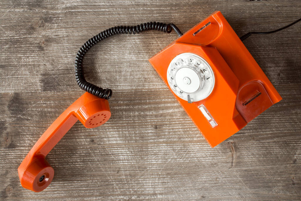 Old orange retro phone with rotary dial. Top view. - Foto, imagen