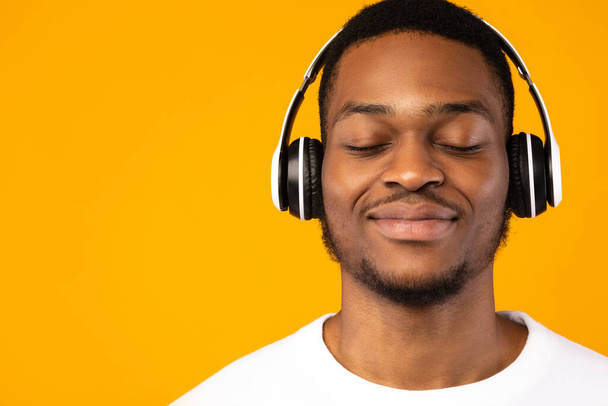 Relaxed Black Guy Listening Music With Eyes Closed, Yellow Background - Fotó, kép