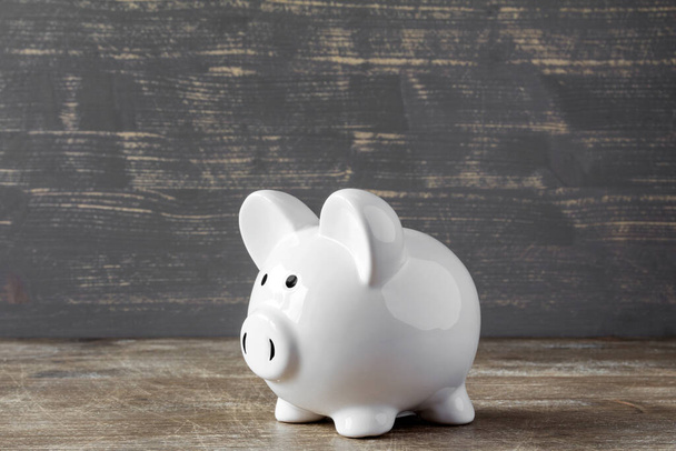Piggy bank on wooden background. Savings concept. - Foto, imagen