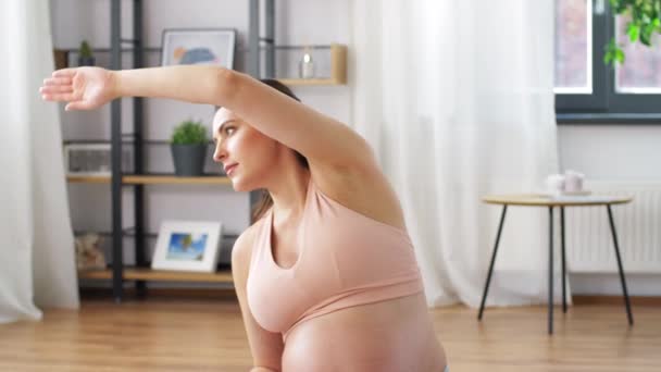 happy pregnant woman doing sports at home - Materiał filmowy, wideo