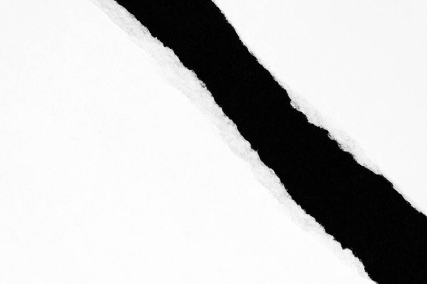 Papel rasgado blanco aislado sobre fondo negro con espacio para copiar - Foto, imagen