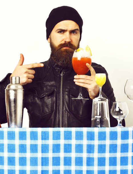 Brutal caucasian hipster holding alcoholic beverage or fresh cocktail - 写真・画像