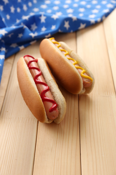 Tasty hot dogs on wooden table - 写真・画像