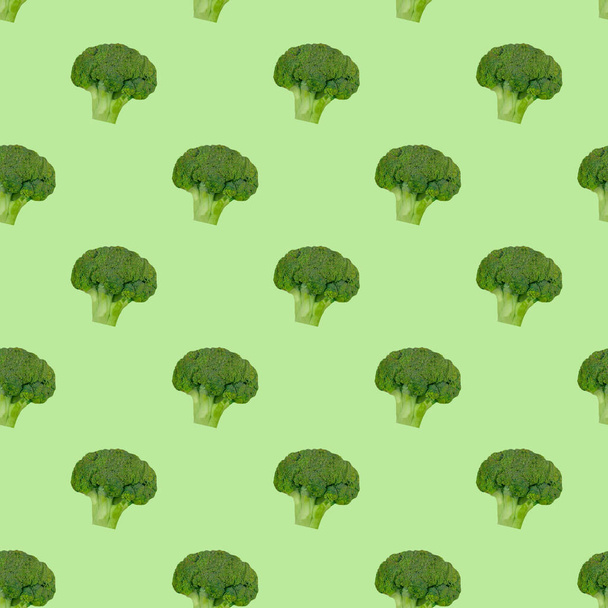 Pattern of broccoli cabbage on a green background. Healthy eating. Vegetarianism - Foto, imagen