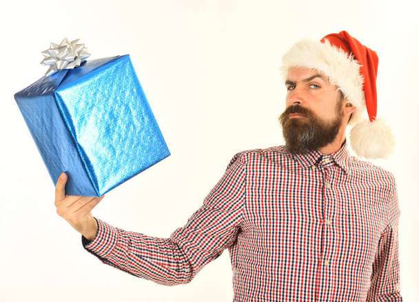 Guy in plaid shirt and Santas hat holds present box - Photo, Image