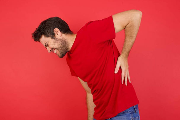 man Suffering of backache, touching back with hand, muscular pain - Photo, Image