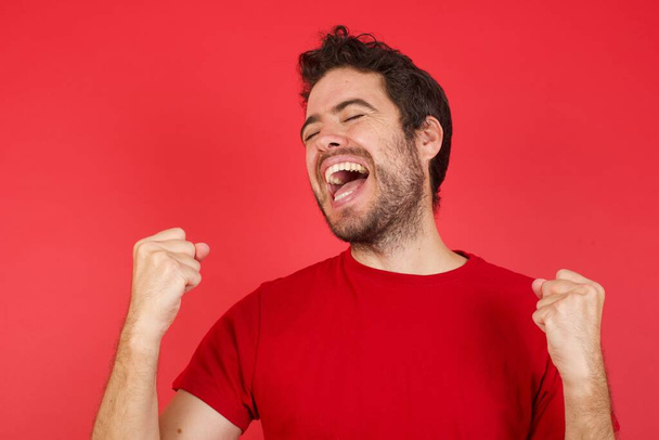 Optimistic happy man Excited in red studio, winner emotions  - Photo, Image