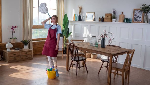 Woman housemaid  tired cleaning the room - Foto, Imagen