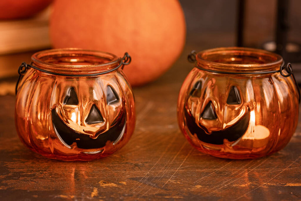 Halloween pumpkin head jack glass lantern. Halloween decoration on wooden table background, selective focus - Image - Foto, afbeelding