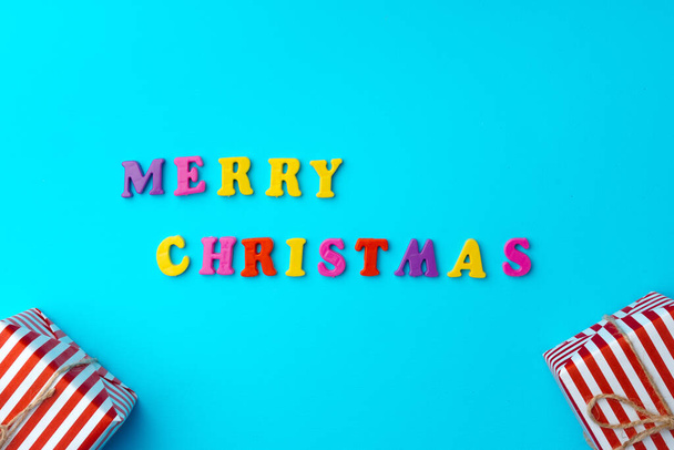 Words Merry Christmas on blue background top view - Фото, зображення