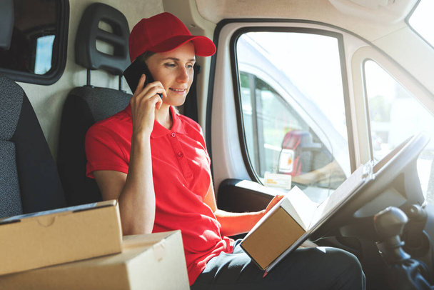 delivery woman talking on mobile phone in van - Photo, Image
