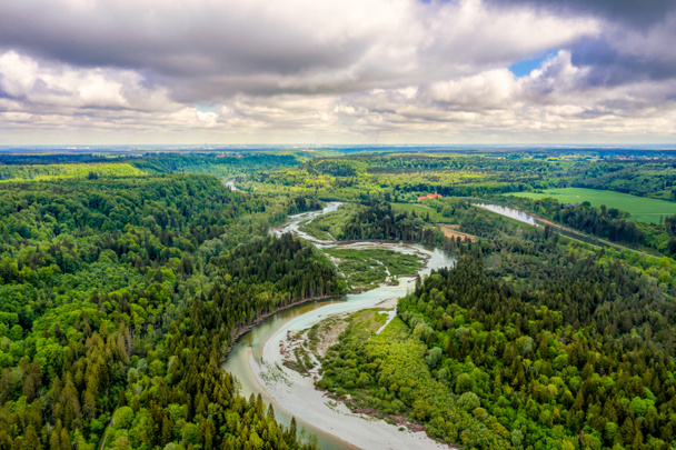 Aerial view at the curvy Isar river at a sunny but cloudy day from nearly 100m from above in southern bavaria, germany. Beautiful nature in spring. - Fotografie, Obrázek