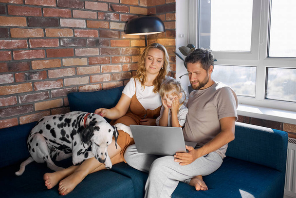 beautiful family spend weekends with dog in cozy home environment - Foto, immagini