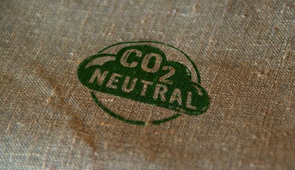 CO2 carbon neutral emission stamp printed on linen sack. Ecology, nature friendly, climate change, green fuel and earth protect concept. - Photo, Image