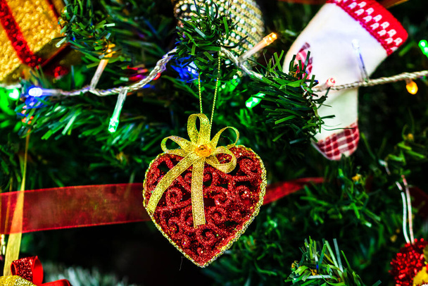 Christmas hanging decorations on fir tree. Decorated Christmas tree. Fir branch with Christmas baubles decorations. - Photo, Image