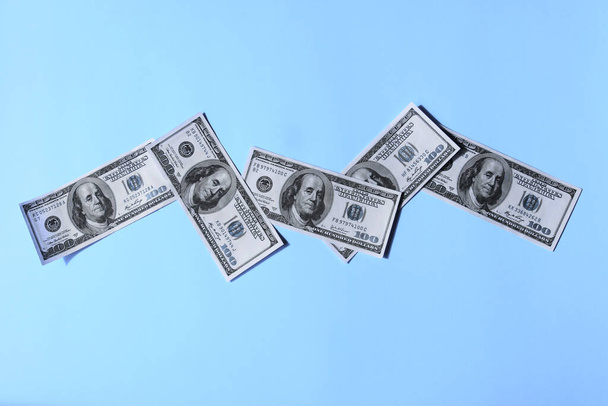 Dollar bills on bright background, top view, horizontal shot. Finance, money concept.  - Foto, imagen