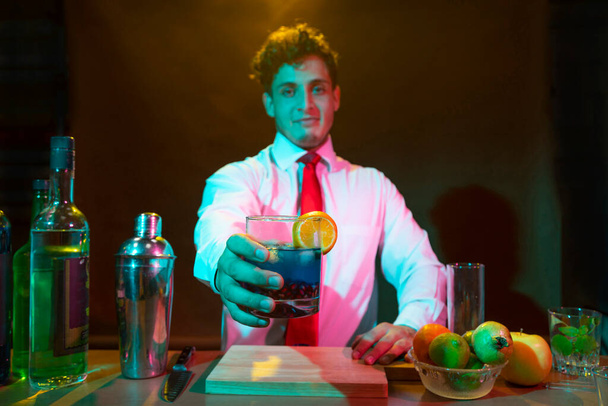 Barman preparing drink with shaker - Photo, Image
