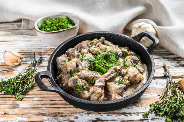 Beef stroganoff with mushrooms in frying pan. White background. Top view. - Photo, Image