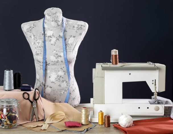 Sewing equipment and mannequin doll against black background - Photo, Image