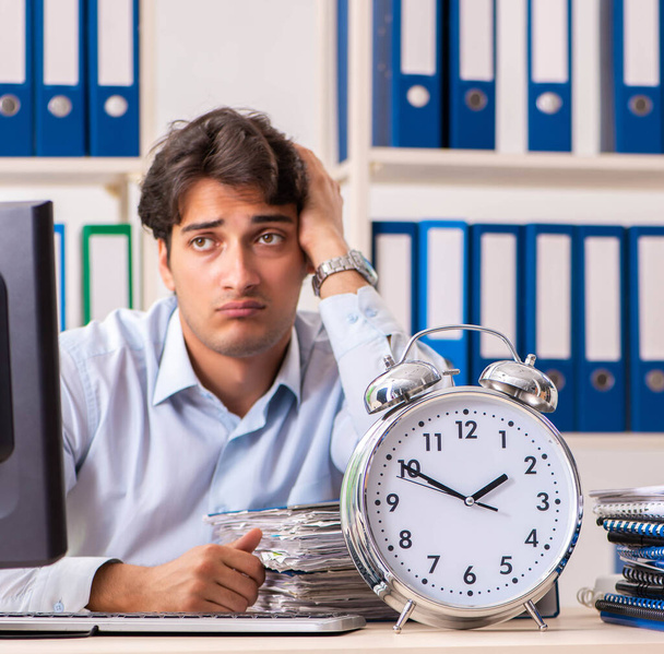 Overloaded busy employee with too much work and paperwork - Photo, Image